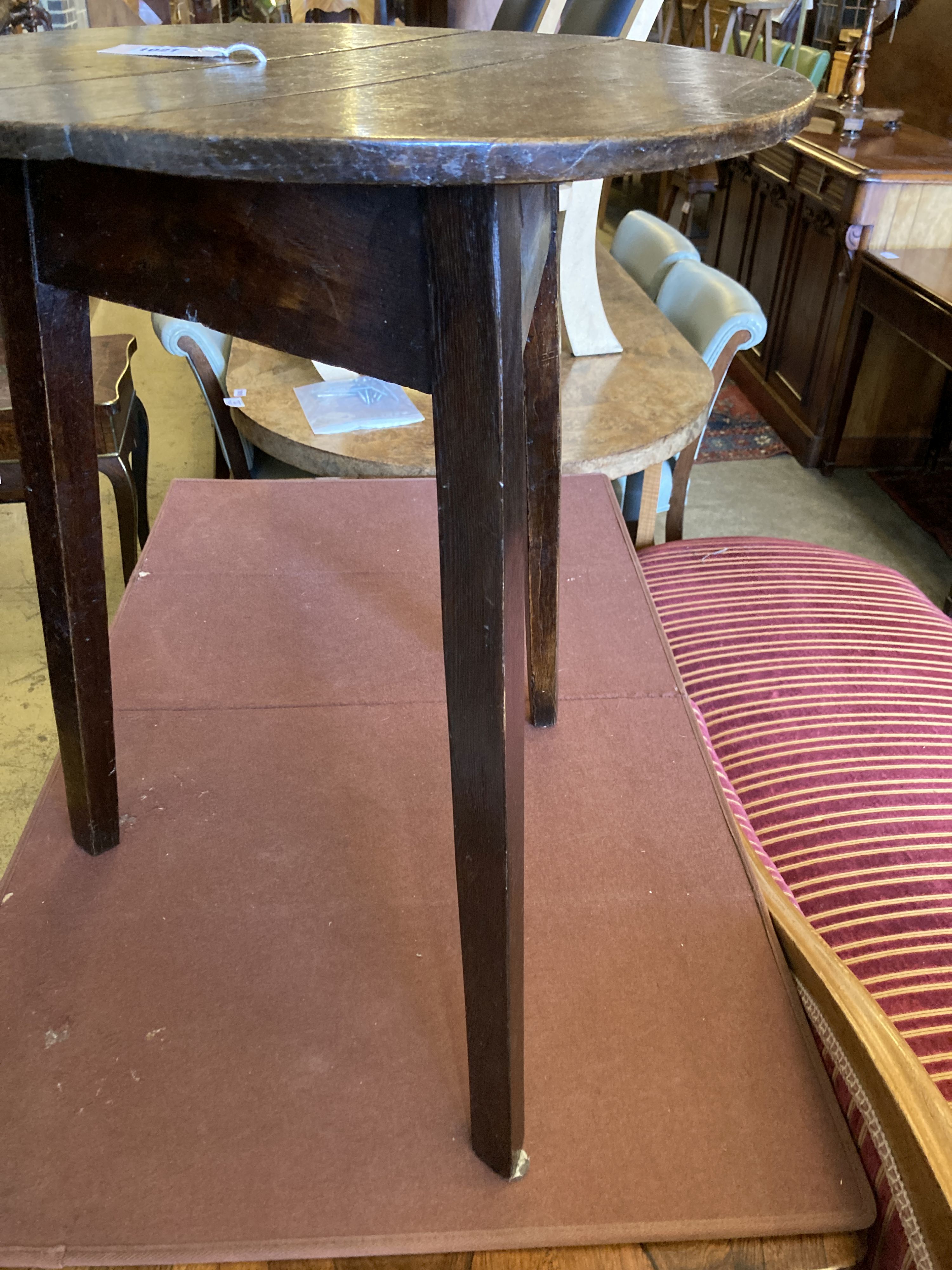 A 19th century circular oak cricket table, 55cm diameter, height 69cm